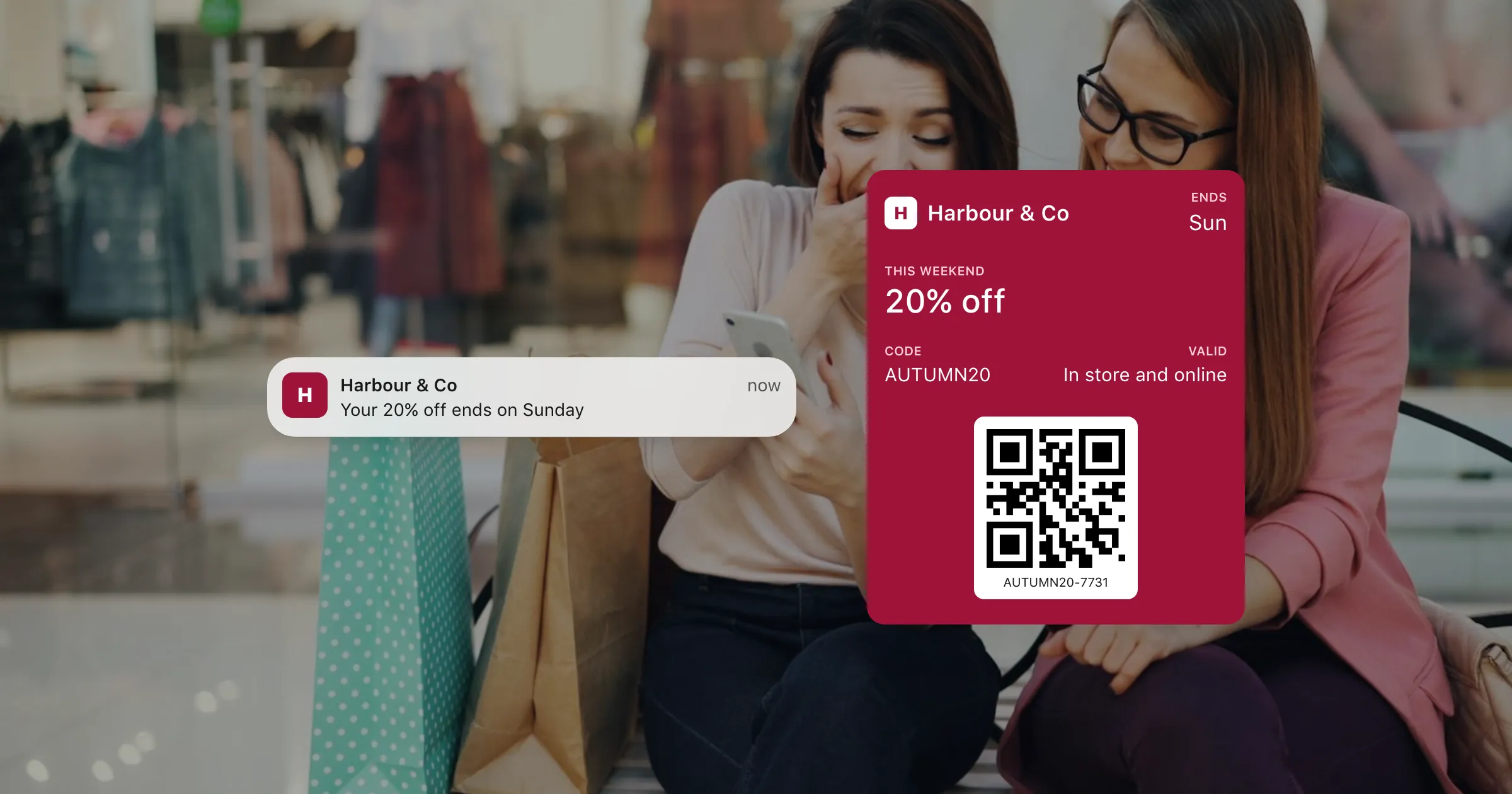 A 20% off coupon in Apple Wallet over a photo of two friends out shopping, with a notification that the offer ends on Sunday.