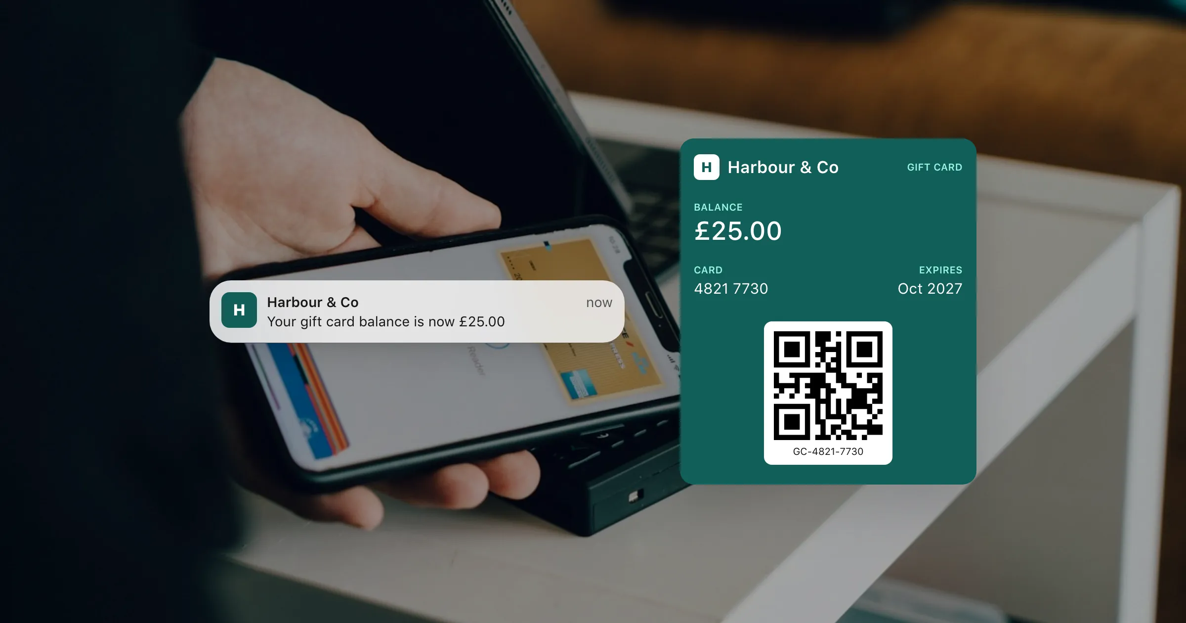 A gift card in Apple Wallet showing a £25.00 balance over a photo of a phone at a card reader.